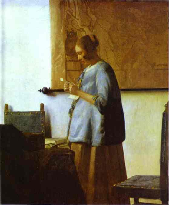 woman in blue reading a letter